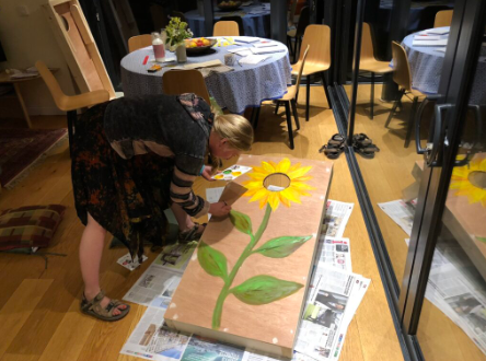 Photo of Emma painting a sunflower